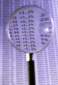 Photograph of a magnifying glass looking at numbers